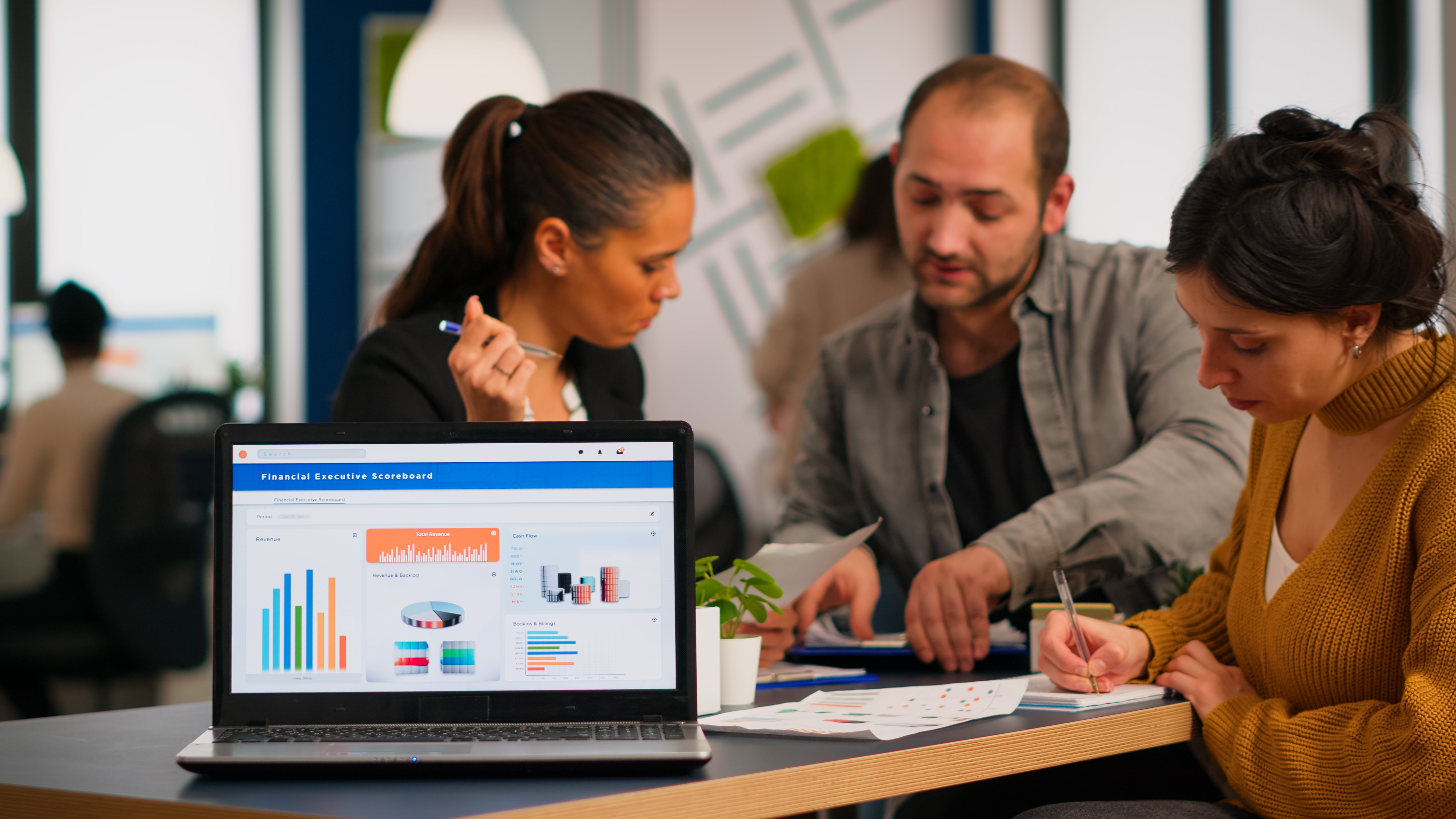 business-woman-talking-about-financial-project-taking-notes-discussing-start-up-ideas-using-laptop-diverse-employees-gathered-co-working-working-process-busy-company-teamwork-help-concept-by-luomnt.tech-by-Sarthak-Upadhyay